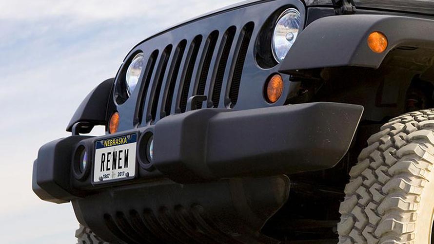 Black Jeep with a license plate that says Renew.