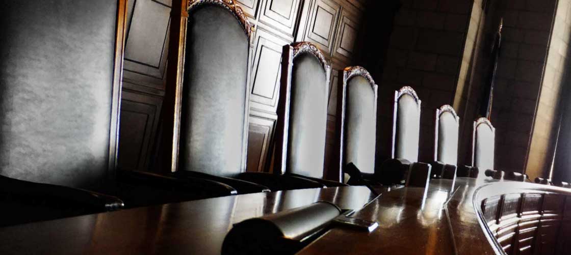 The seats of justice sit behind the shiny desk of law in the hall of liberty.