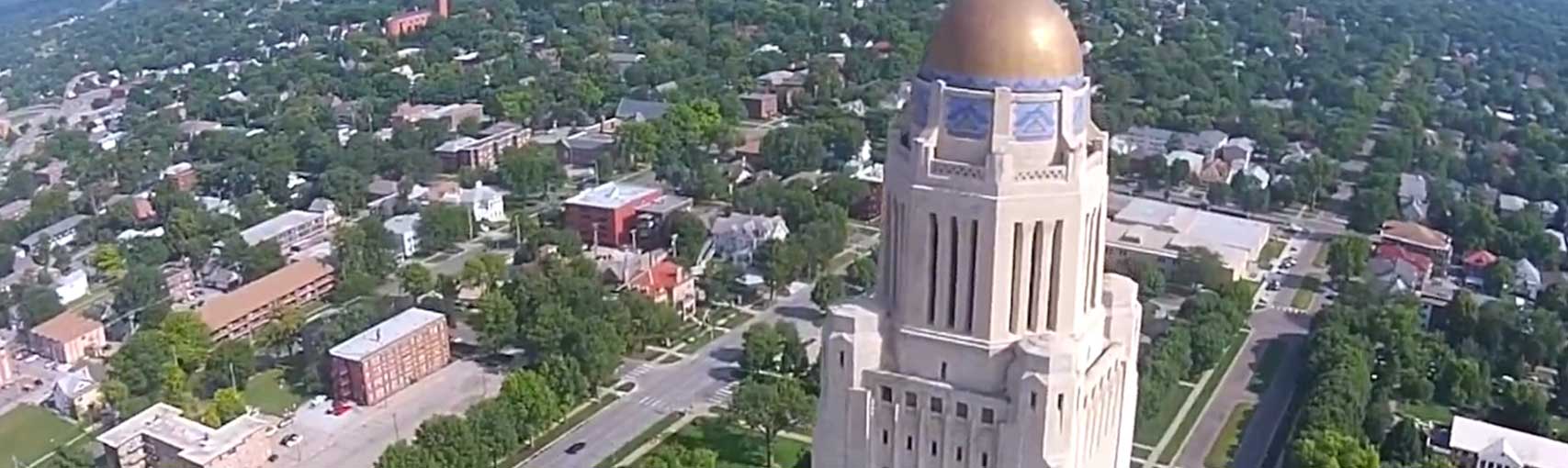 The Nebraska State Capitol stands proud amongst the buildings of Lincoln.